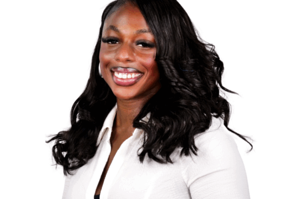 Woman with long wavy hair, wearing a white button-up top, smiling brightly against a white background.