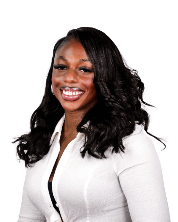 Woman with long wavy hair, wearing a white button-up top, smiling brightly against a white background.
