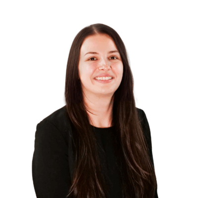 Woman with long straight brown hair, wearing a black top, smiling in front of a white background.