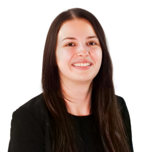 Woman with long straight brown hair, wearing a black top, smiling in front of a white background.