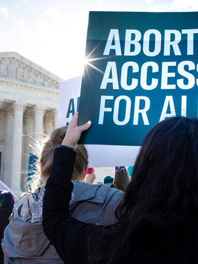 Pro-choice demonstrators outside the Supreme Court with signs advocating abortion access for all.