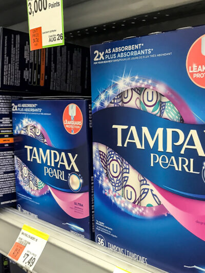 Tampax tampon boxes on the shelf in a pharmacy.