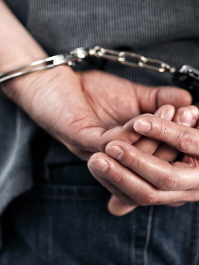 Man with hands handcuffed behind his back