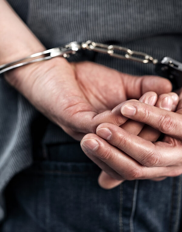 Man with hands handcuffed behind his back