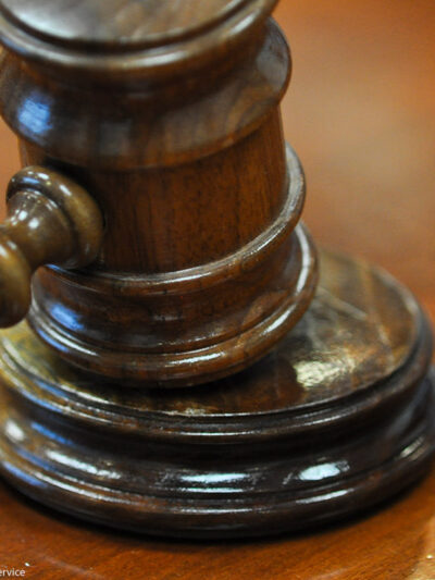 Photo of gavel on judge's bench.