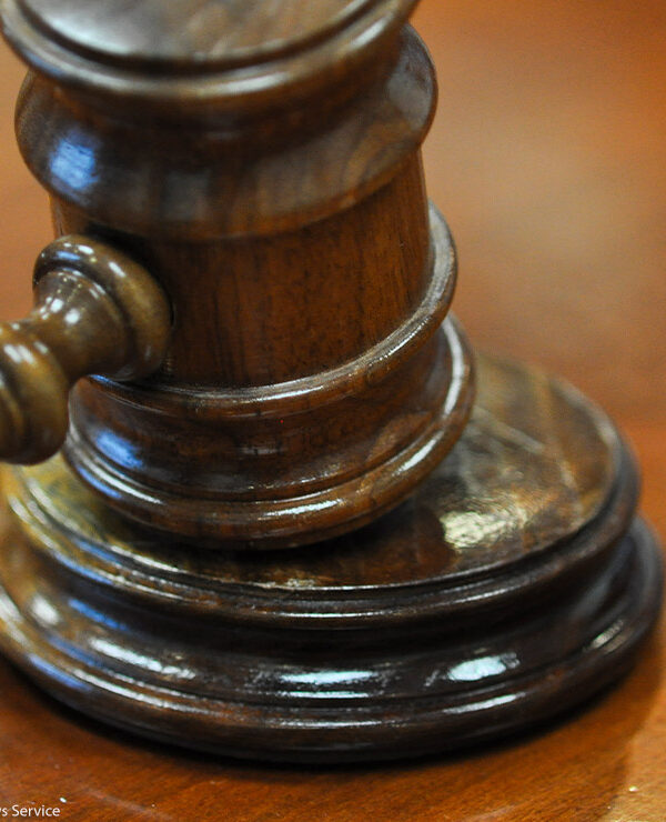 Photo of gavel on judge's bench.