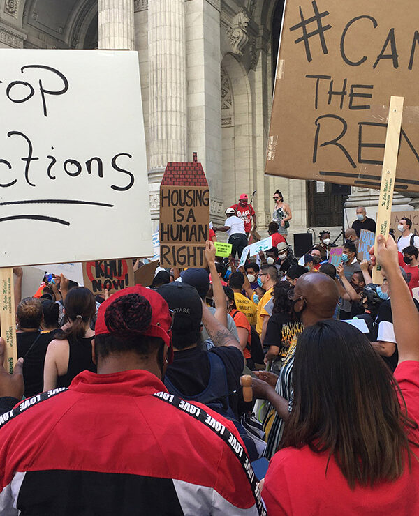 Protesters demonstrating with signs calling for rent relief and an end to evictions.