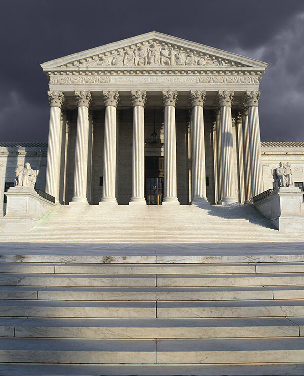 The Supreme Court beneath a cloudy sky.