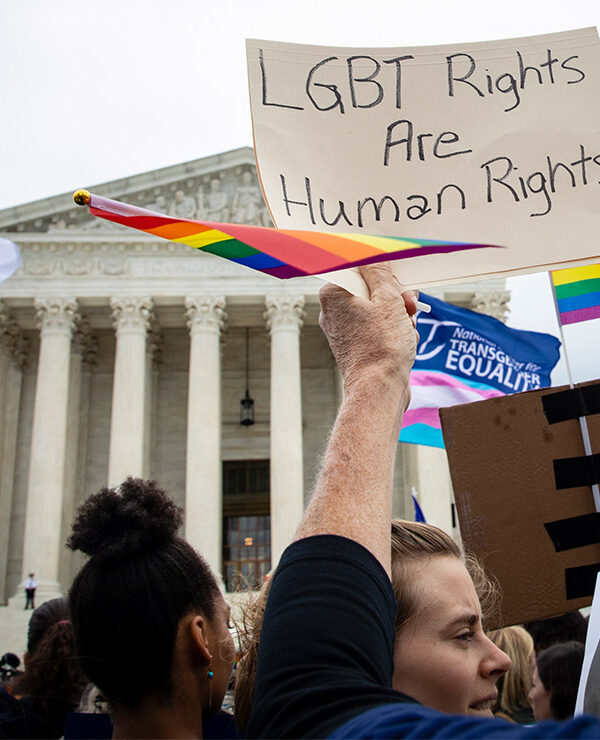Demonstrators outside the Supreme Court with signs advocating for the rights of LGBT people.