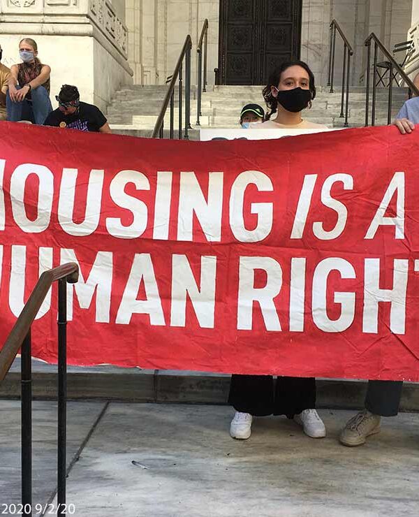 Protestors hold aloft a saying HOUSING IS A HUMAN RIGHT at a protest in New York City, September 2, 2020