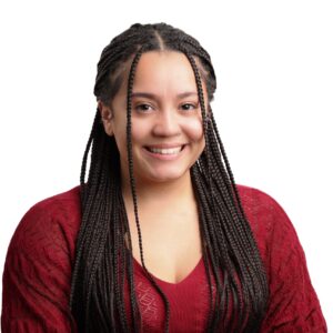 Headshot of Kaylah. She is a Black woman with braided hair. She is wearing a red long sleeve top.