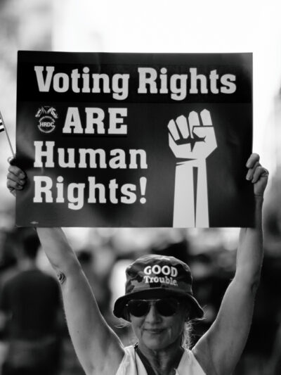 Woman holding sign that says "Voting Rights are Human Rights"
