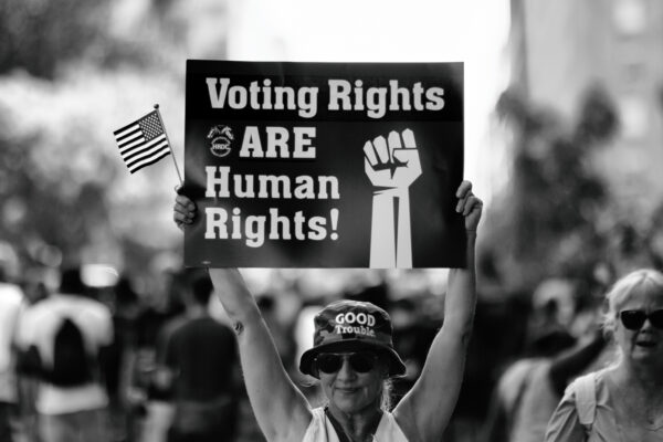 Woman holding sign that says "Voting Rights are Human Rights"