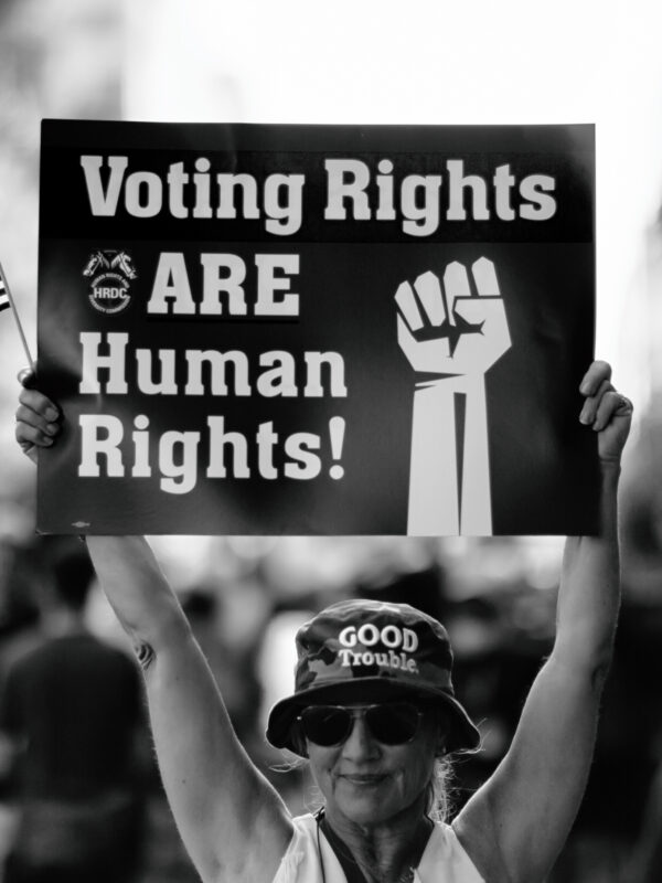 Woman holding sign that says "Voting Rights are Human Rights"