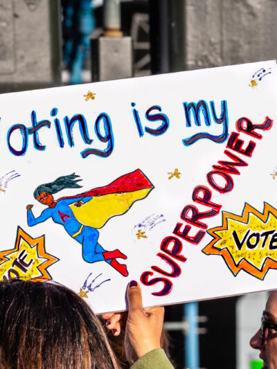Picture of a protest sign that reads "voting is my superpower"