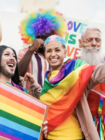 People at pride rally holding flag