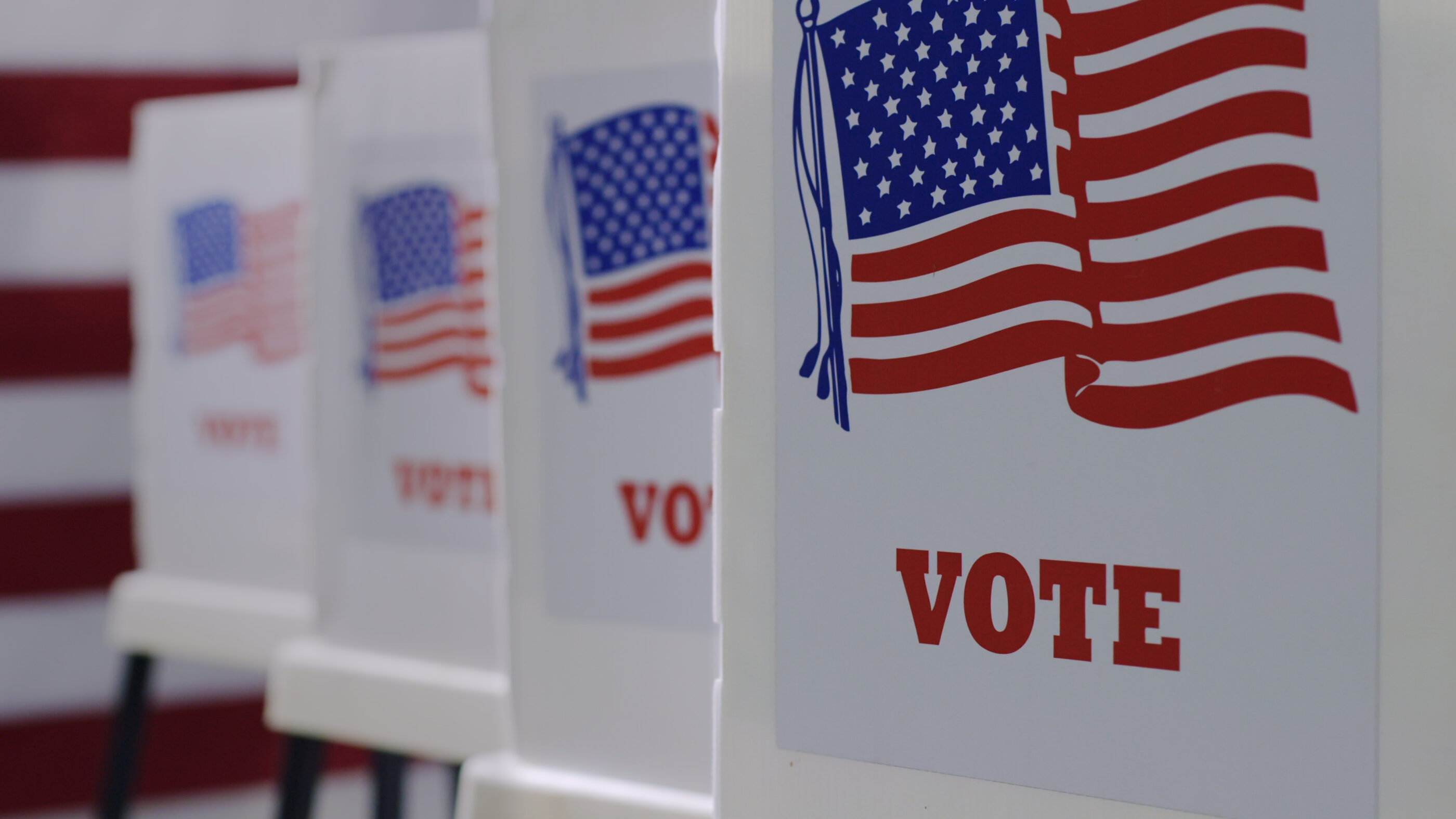 row of 4 voter boxes. On the front is the American flag and underneath in red it reads "vote."