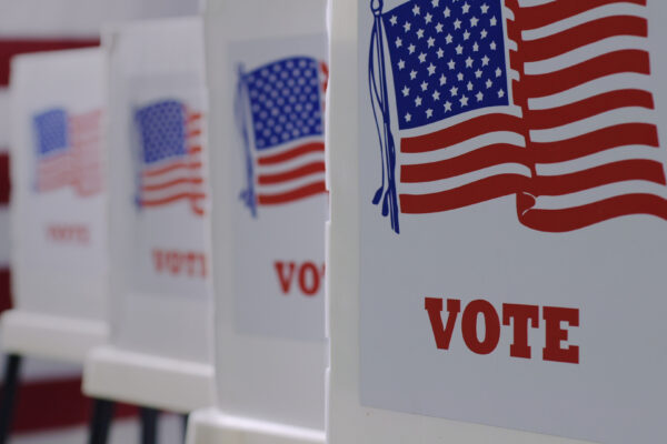 row of 4 voter boxes. On the front is the American flag and underneath in red it reads "vote."