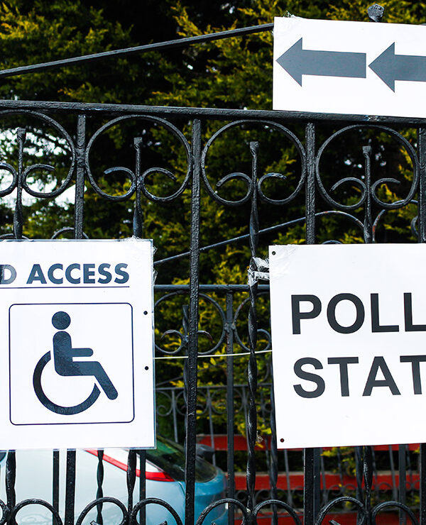 A polling station sign and disabled access sign.