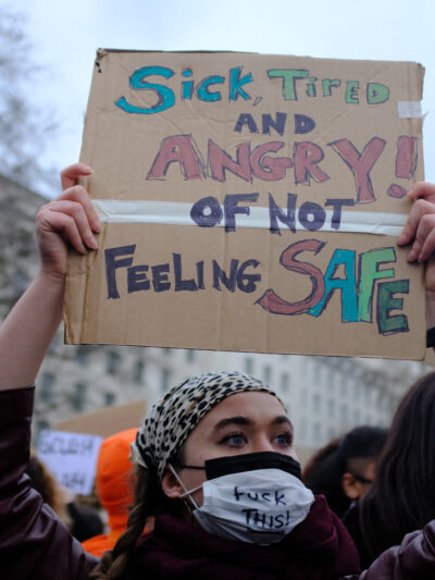 Protest sign that says, "sick, tired and angry of not feeling safe."