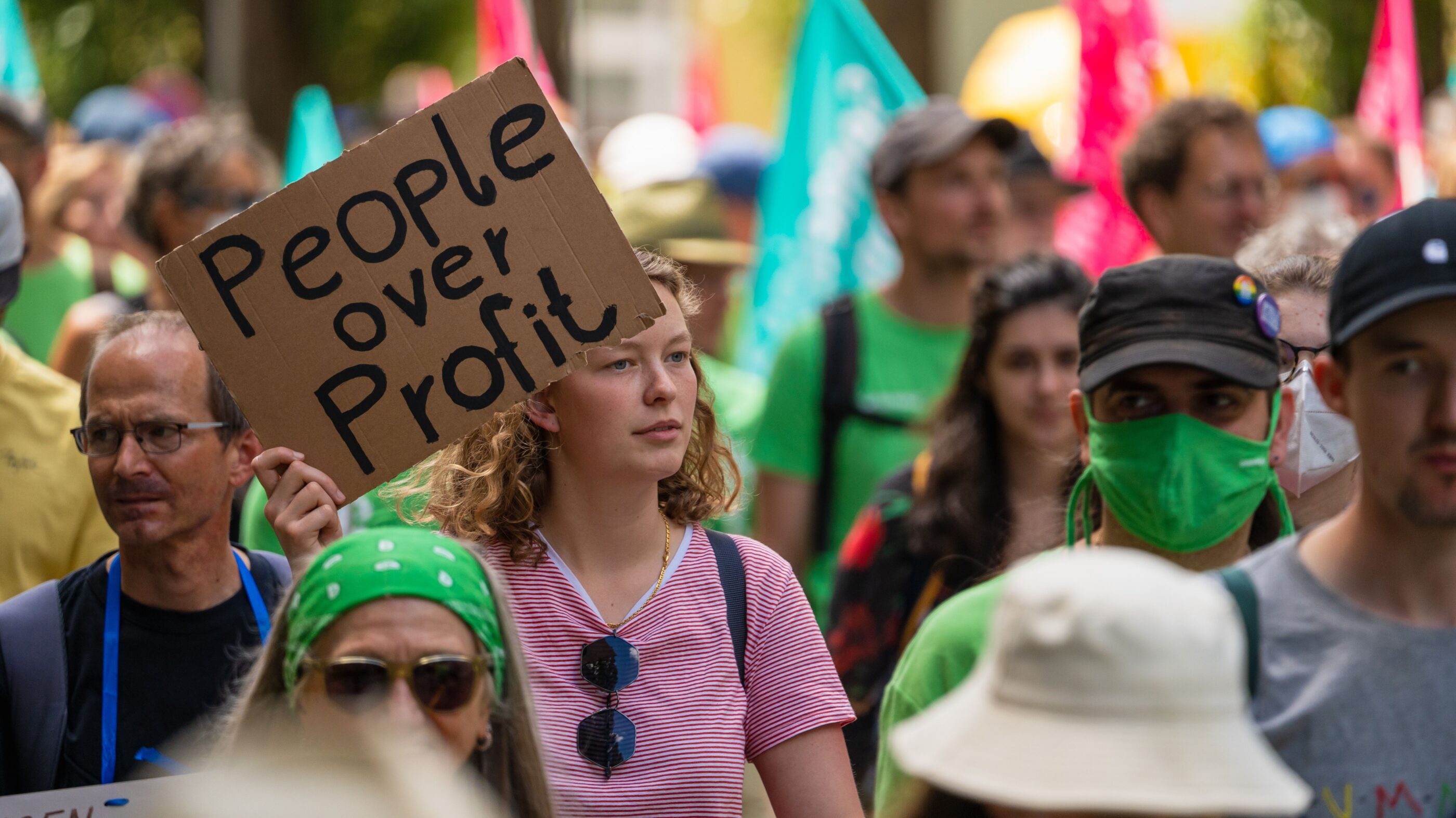 Protest sign that says "people over profit."
