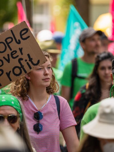 Protest sign that says "people over profit."
