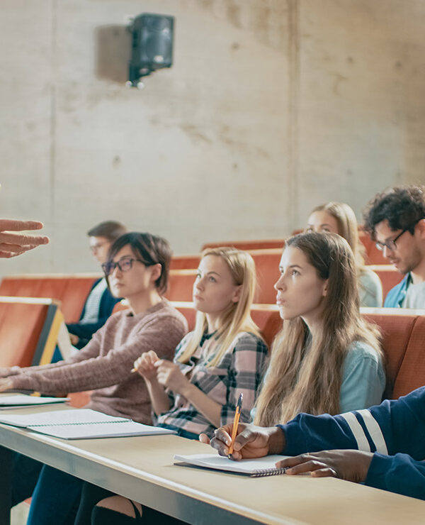 A professor holding a lecture to a group of students.