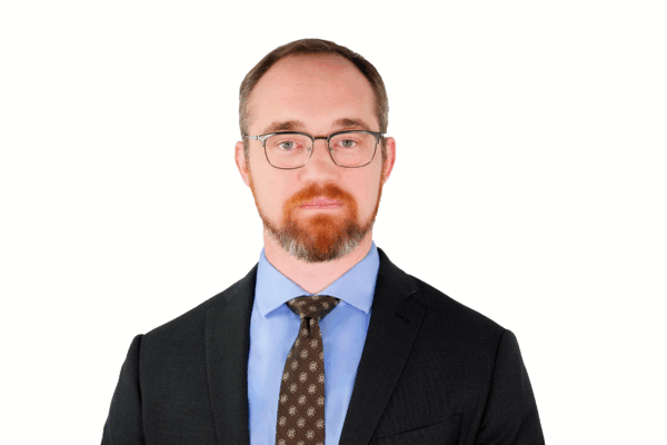 Chris in front of a white background.
