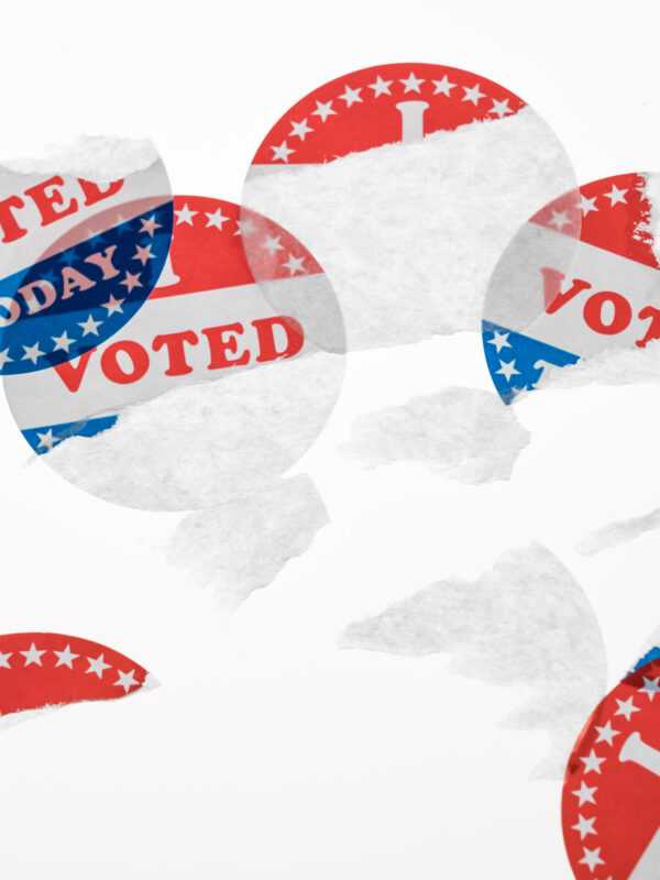 Torn and defaced I Voted Today stickers in aftermath of the US elections isolated on white background