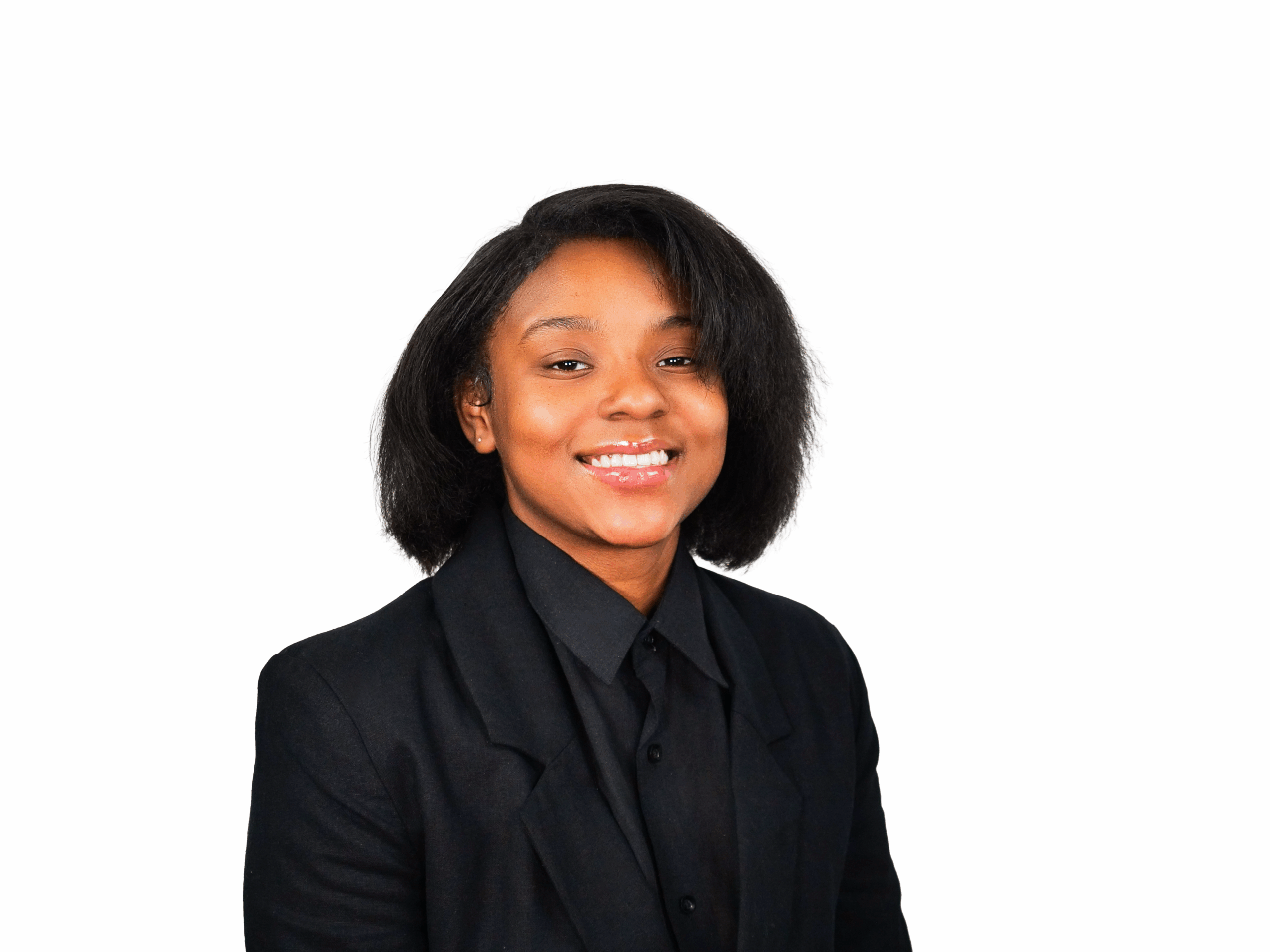 Kash Williams in front of a white background. She is wearing a black top and has a gold necklace on,