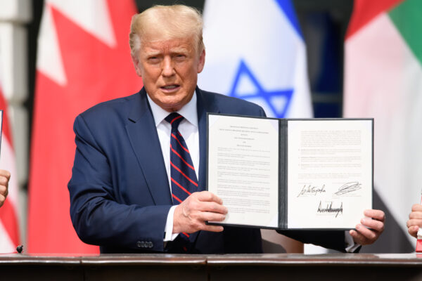 trump holding a signed executive order