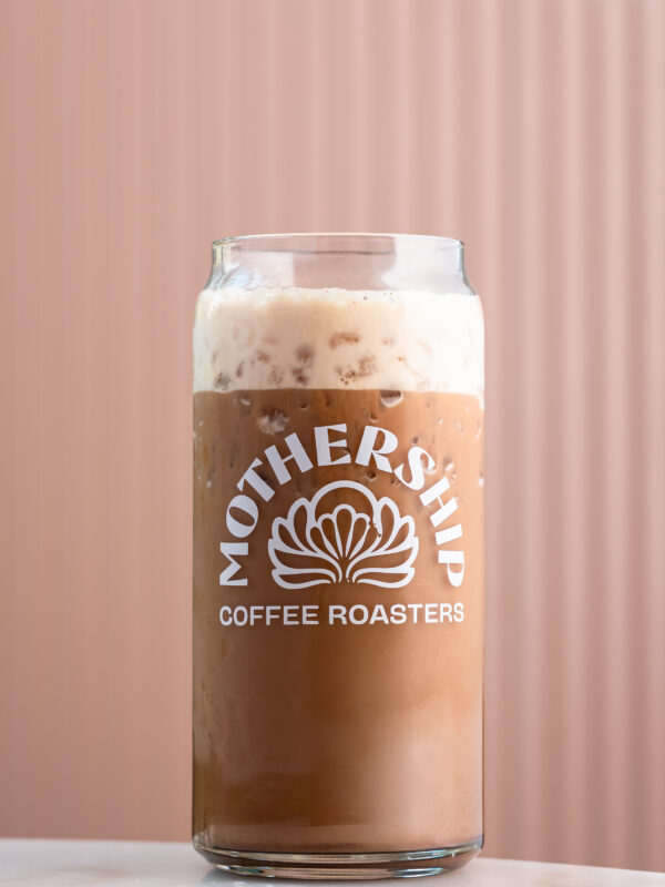 Cherry dark mocha cold brew latte in glass cup with Mothership logo