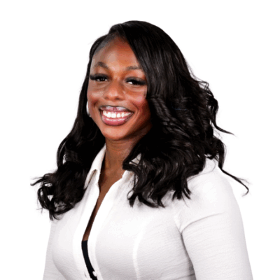 Woman with long wavy hair, wearing a white button-up top, smiling brightly against a white background.