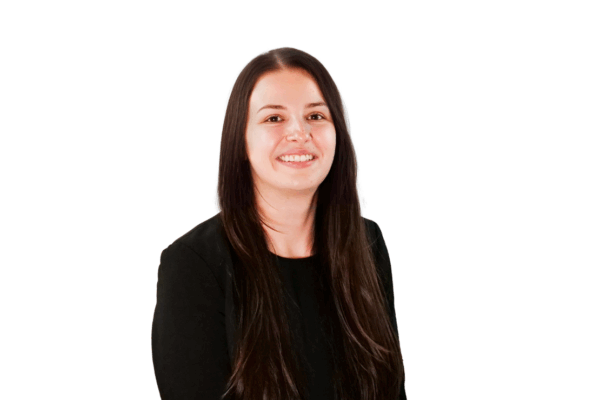 Woman with long straight brown hair, wearing a black top, smiling in front of a white background.