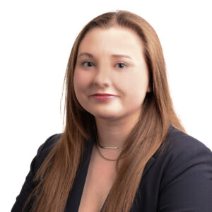 Headshot of Samantha. She is a white woman with dirty blonde hair. She is wearing a navy blazer.