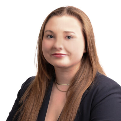 Headshot of Samantha. She is a white woman with dirty blonde hair. She is wearing a navy blazer.