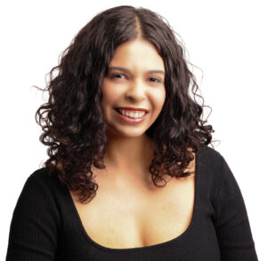 Headshot of Samantha. She is a brown woman with dark brown curly hair. She is wearing a long sleeve black top.