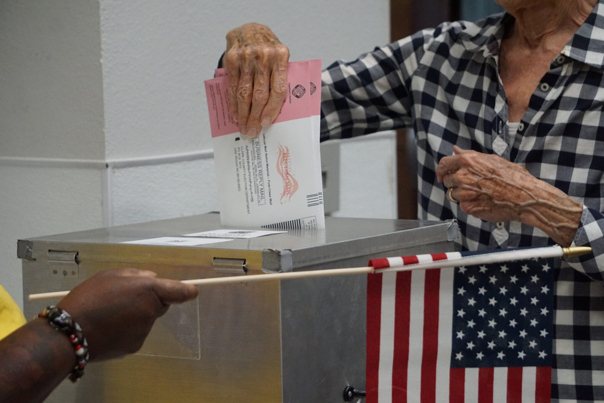 Voter placing Nevada mail ballot into drop box.