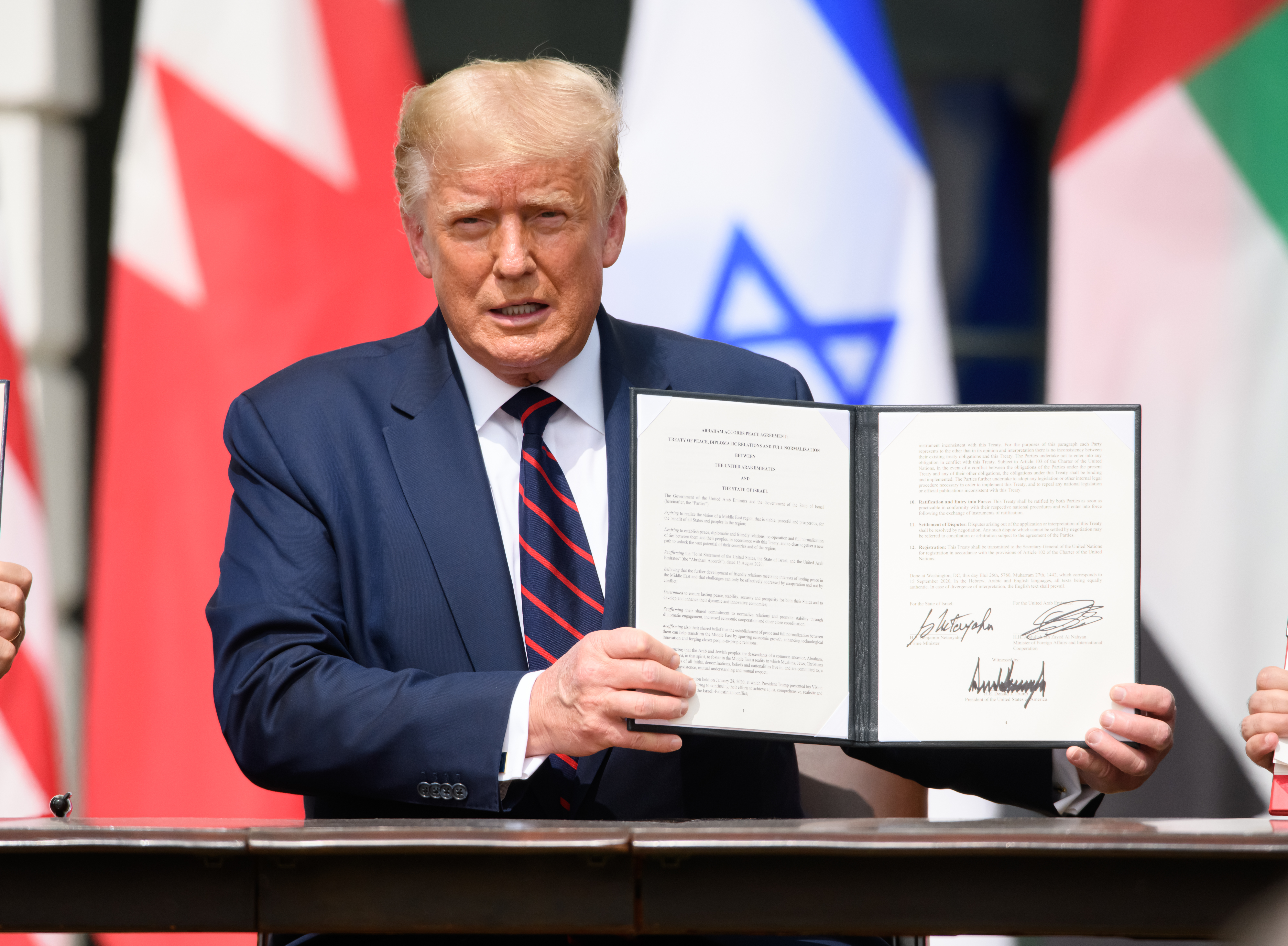 trump holding a signed executive order