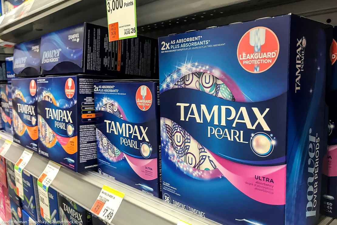 Tampax tampon boxes on the shelf in a pharmacy.