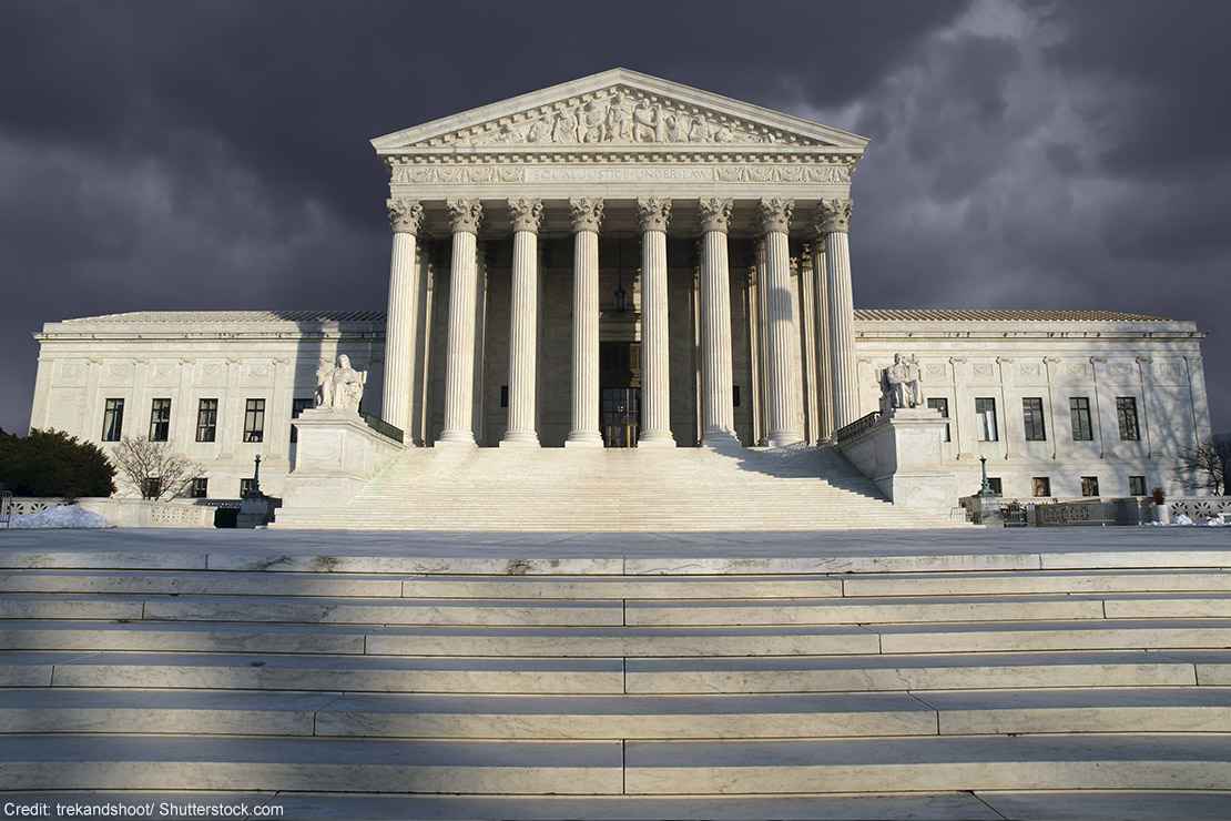 The Supreme Court beneath a cloudy sky.