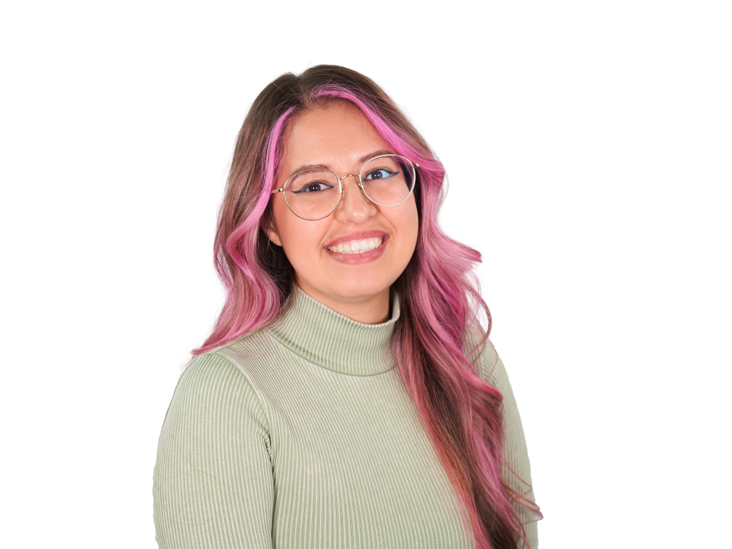 Headshot of Jessica. She is wearing a grayish green turtle neck, glasses, and has pink hair.