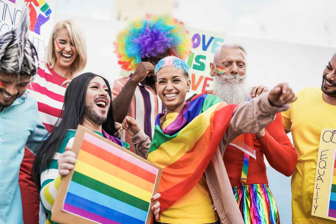 People at pride rally holding flag