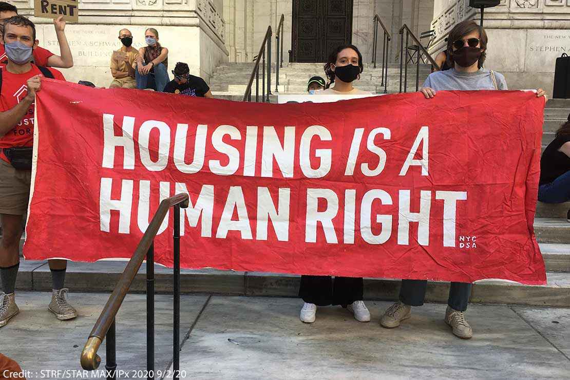 Protestors hold aloft a saying HOUSING IS A HUMAN RIGHT at a protest in New York City, September 2, 2020