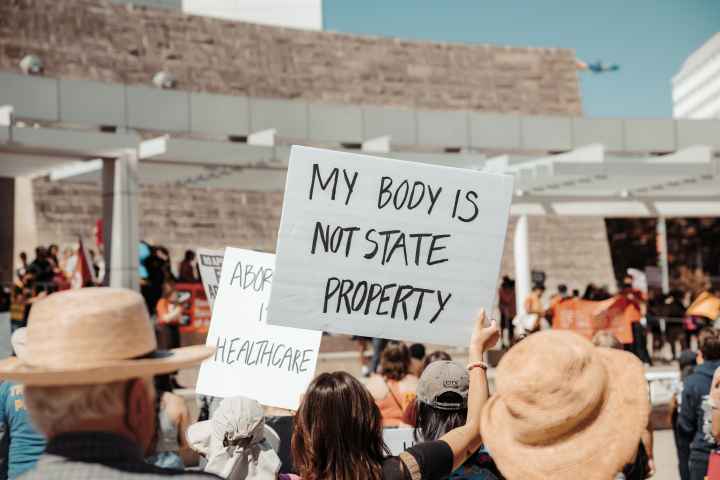 protest sign that says "my body is not state property"