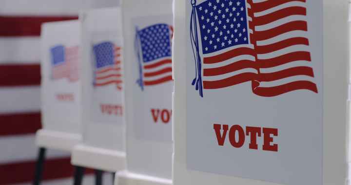 row of 4 voter boxes. On the front is the American flag and underneath in red it reads "vote."