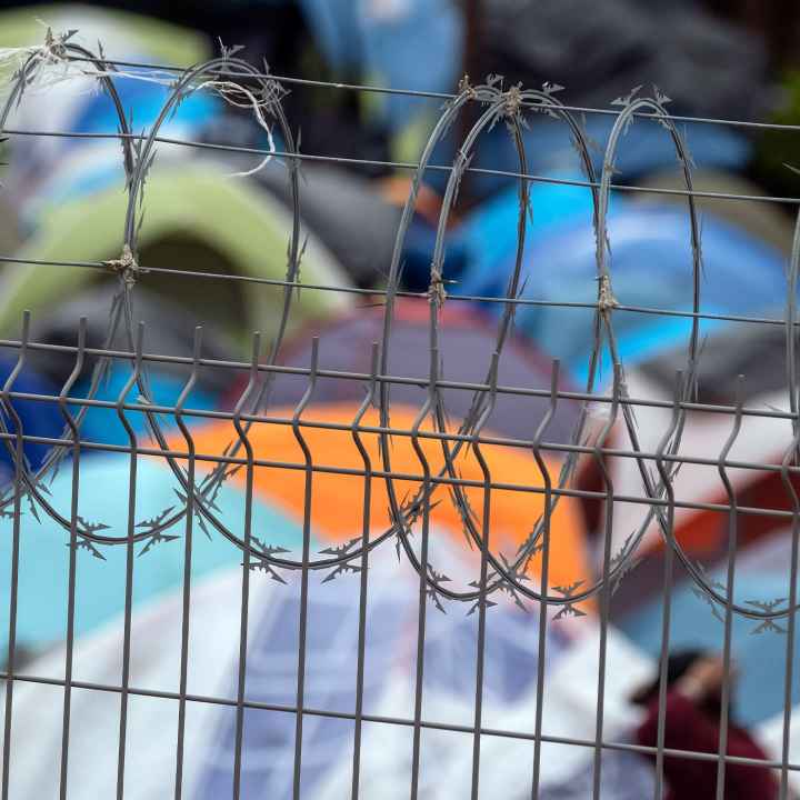 Barbed wire fence at a refugee camp for migrants and asylum seekers in Matamoros, Mexico, October 2019. Guillermo Arias for the ACLU.
