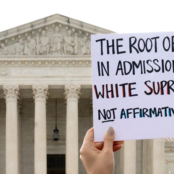 Protest sign that says "The root of bias in admissions is white supremacy, not affirmative action."