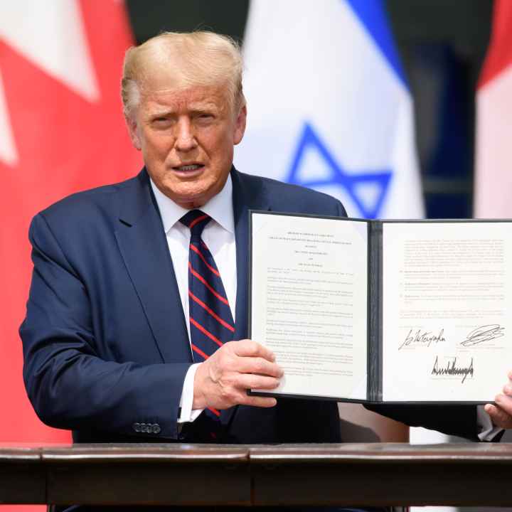 trump holding a signed executive order