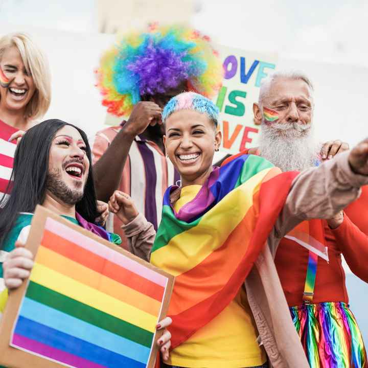 People at pride rally holding flag